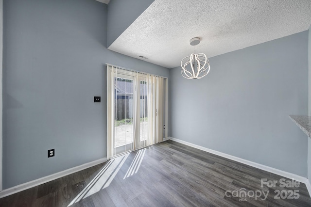8520 Mission Hills Rd, Charlotte, NC 28227 - unfurnished dining area featuring a chandelier, dark wood finished floors, and a textured ceiling