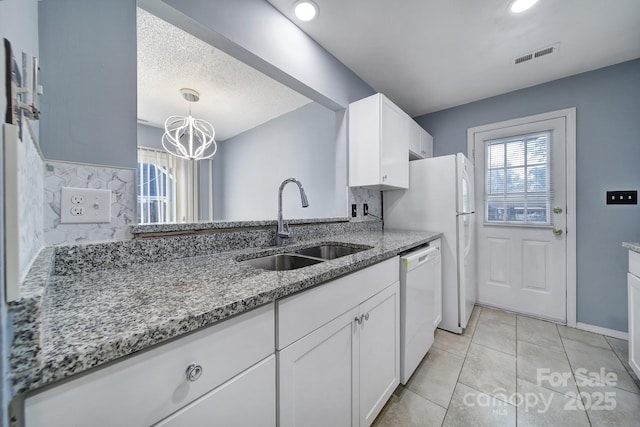 8520 Mission Hills Rd, Charlotte, NC 28227 - kitchen with white dishwasher, white cabinets, healthy amount of natural light, light stone countertops, and a textured ceiling