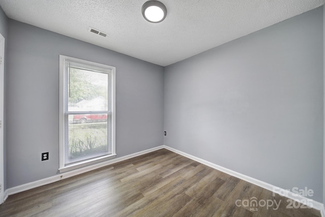 8520 Mission Hills Rd, Charlotte, NC 28227 - spare room featuring wood finished floors and a textured ceiling
