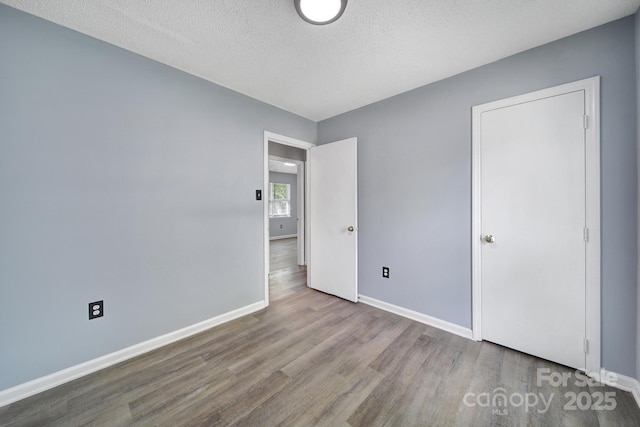 8520 Mission Hills Rd, Charlotte, NC 28227 - unfurnished bedroom with wood finished floors and a textured ceiling