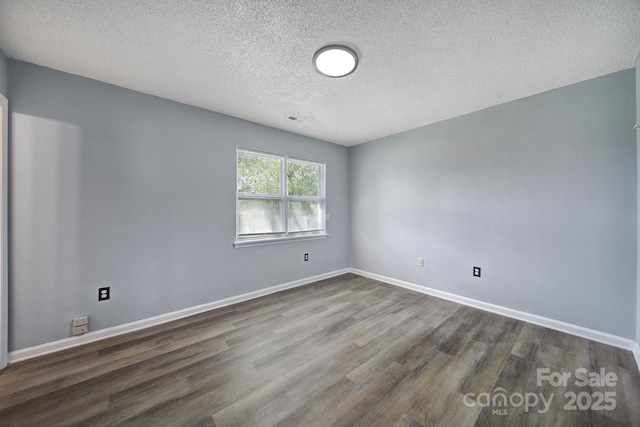 8520 Mission Hills Rd, Charlotte, NC 28227 - empty room featuring a textured ceiling and dark wood-style floors