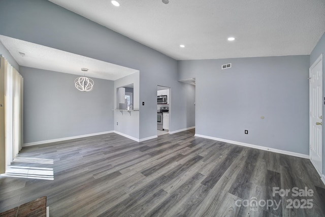 8520 Mission Hills Rd, Charlotte, NC 28227 - unfurnished living room featuring dark wood-style floors, recessed lighting, and a chandelier