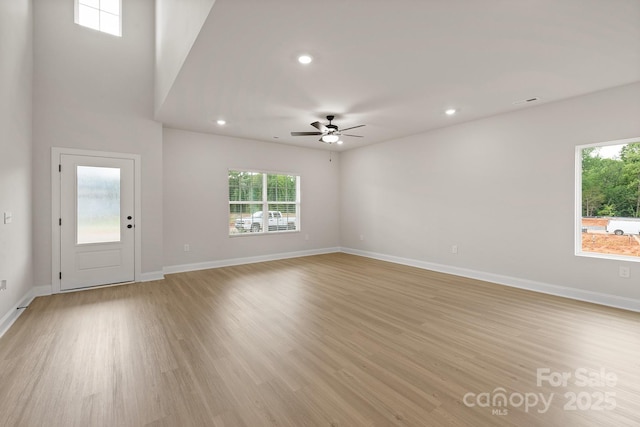 7225 Jerimoth Dr, Charlotte, NC 28215 - unfurnished living room featuring healthy amount of natural light, a ceiling fan, light wood finished floors, and recessed lighting