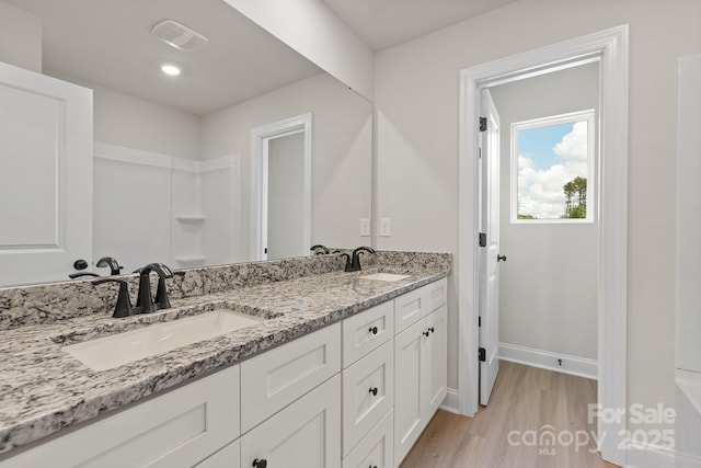 7225 Jerimoth Dr, Charlotte, NC 28215 - full bathroom featuring double vanity, wood finished floors, and baseboards