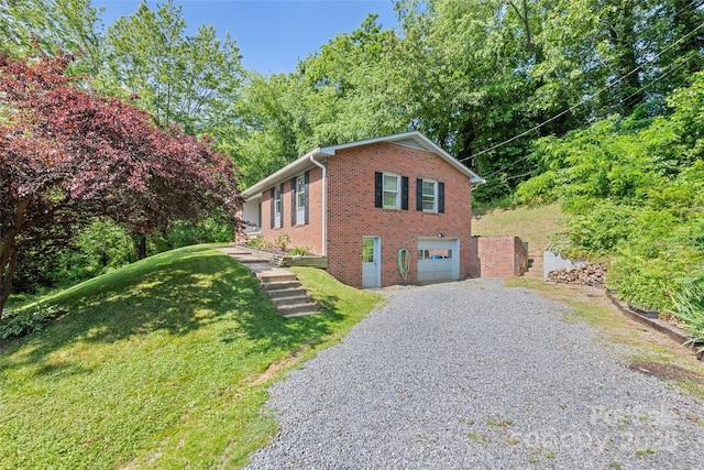 40 Autumn St, Canton, NC 28716 - view of property exterior with driveway, brick siding, an attached garage, and a yard