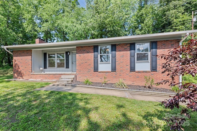40 Autumn St, Canton, NC 28716 - view of front of home with a front lawn, a chimney, and brick siding