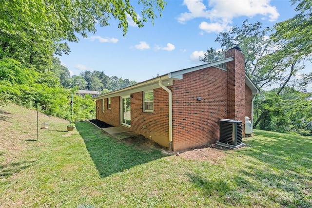 40 Autumn St, Canton, NC 28716 - view of home's exterior featuring a chimney, a yard, brick siding, and cooling unit