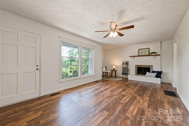 40 Autumn St, Canton, NC 28716 - unfurnished living room with wood finished floors, a textured ceiling, a ceiling fan, baseboards, and a fireplace