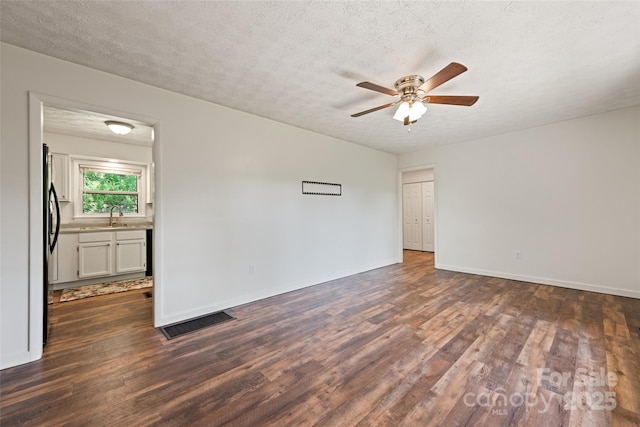 40 Autumn St, Canton, NC 28716 - unfurnished room with a sink, dark wood-style flooring, ceiling fan, baseboards, and a textured ceiling