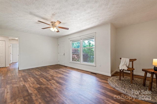 40 Autumn St, Canton, NC 28716 - spare room featuring dark wood-style flooring, a textured ceiling, baseboards, and a ceiling fan