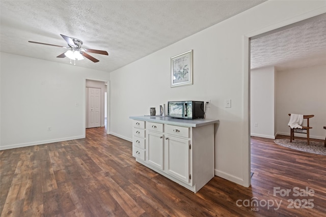 40 Autumn St, Canton, NC 28716 - kitchen featuring a textured ceiling, dark wood-type flooring, white cabinetry, a ceiling fan, and baseboards