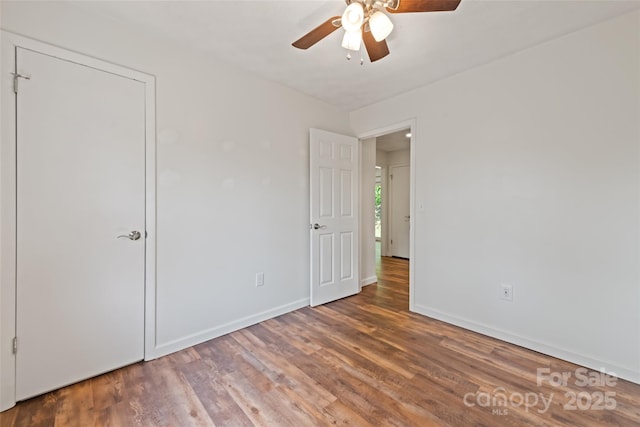 40 Autumn St, Canton, NC 28716 - unfurnished bedroom with wood finished floors, baseboards, and ceiling fan
