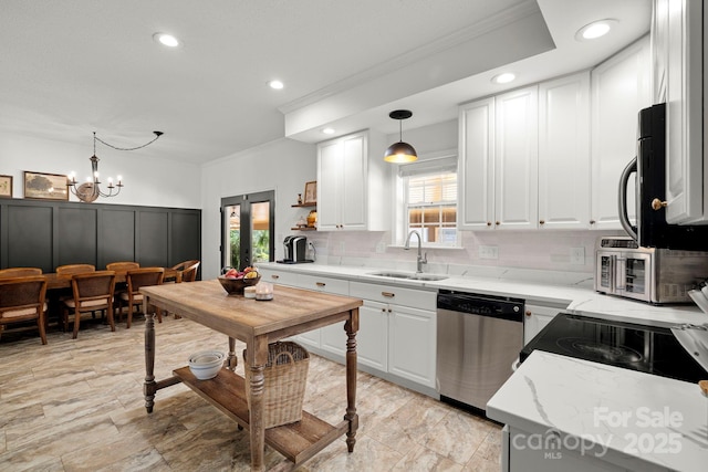 491 Paint Fork Rd, Barnardsville, NC 28709 - kitchen featuring appliances with stainless steel finishes, a sink, ornamental molding, healthy amount of natural light, and backsplash