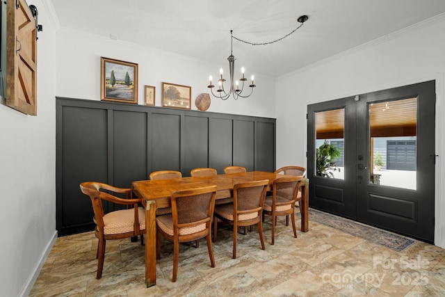 491 Paint Fork Rd, Barnardsville, NC 28709 - dining area with ornamental molding, a chandelier, a decorative wall, a wainscoted wall, and a barn door