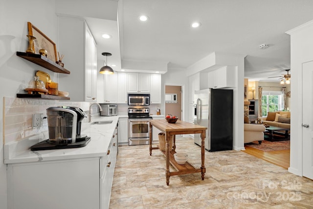 491 Paint Fork Rd, Barnardsville, NC 28709 - kitchen featuring stainless steel appliances, open shelves, a ceiling fan, white cabinetry, and a sink
