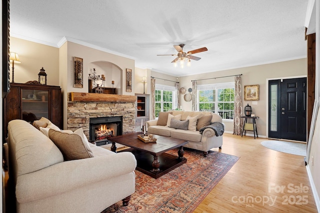 491 Paint Fork Rd, Barnardsville, NC 28709 - living room featuring ceiling fan, baseboards, wood finished floors, crown molding, and a fireplace