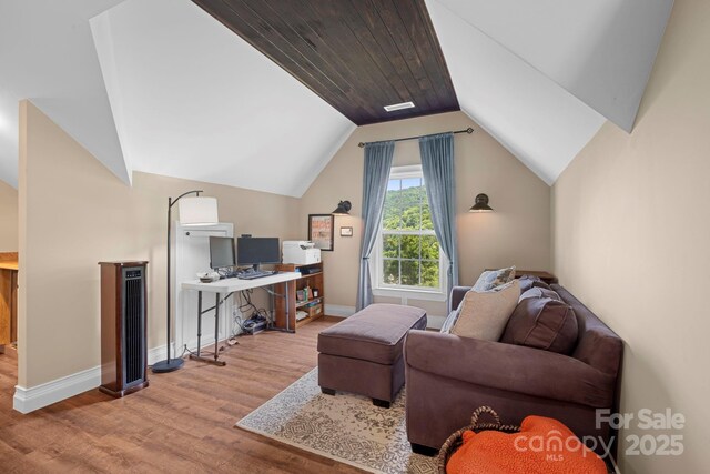 491 Paint Fork Rd, Barnardsville, NC 28709 - living area with wood finished floors, vaulted ceiling, a desk, and baseboards