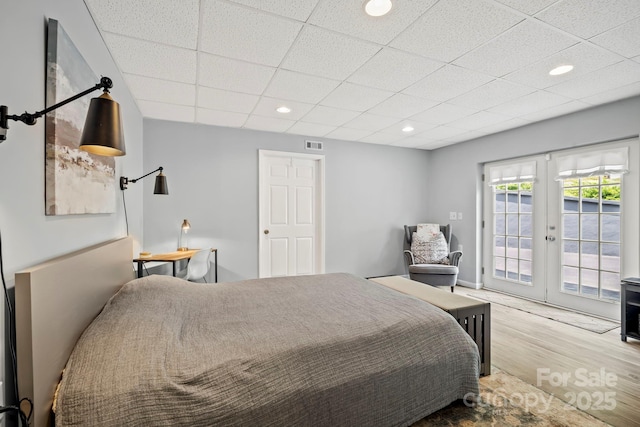 491 Paint Fork Rd, Barnardsville, NC 28709 - bedroom featuring access to exterior, wood finished floors, french doors, a paneled ceiling, and recessed lighting