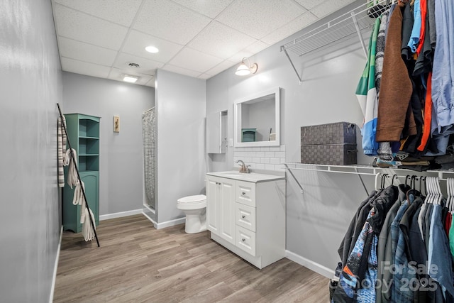 491 Paint Fork Rd, Barnardsville, NC 28709 - full bathroom featuring vanity, wood finished floors, a drop ceiling, a shower stall, and toilet