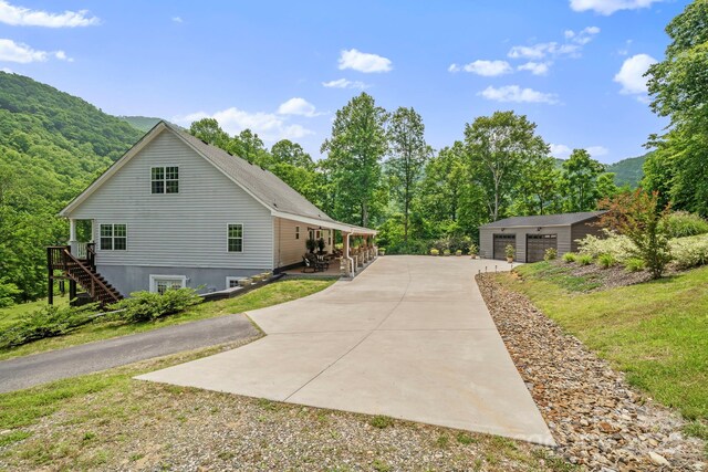 491 Paint Fork Rd, Barnardsville, NC 28709 - view of side of home featuring stairway, a garage, and an outbuilding