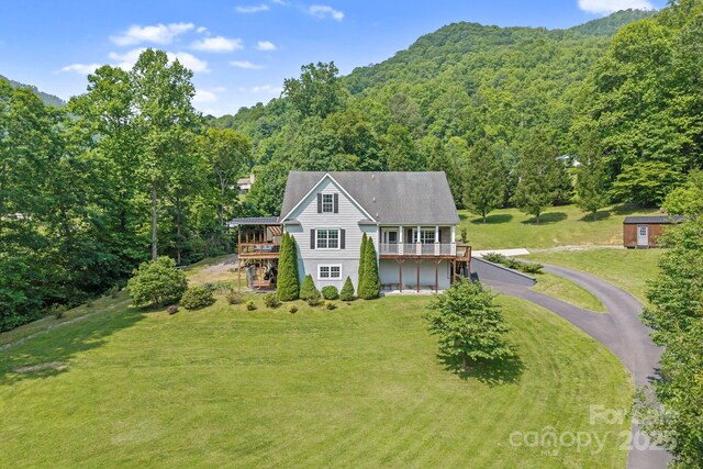 491 Paint Fork Rd, Barnardsville, NC 28709 - view of front of home featuring a wooded view, driveway, a front lawn, and a deck