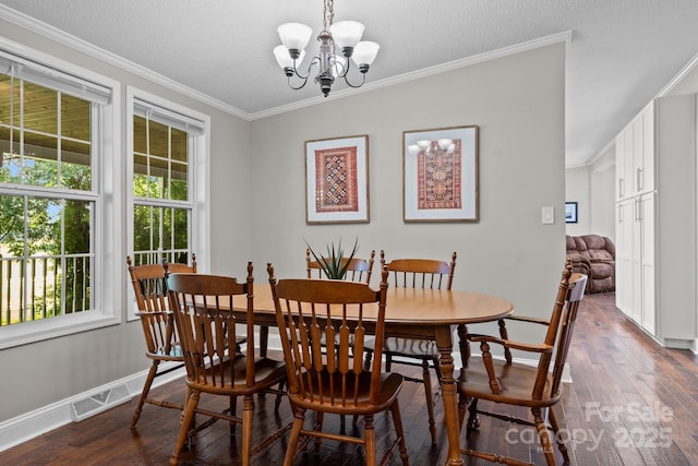 34 Edwards St, Asheville, NC 28806 - dining area with a chandelier, dark wood-style floors, healthy amount of natural light, crown molding, and a textured ceiling