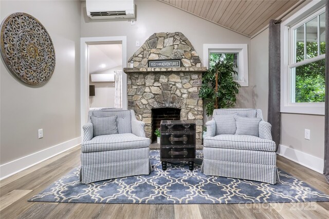 22 Moore Cir, Black Mountain, NC 28711 - sitting room with a wall mounted air conditioner, wooden ceiling, vaulted ceiling, a stone fireplace, and wood finished floors