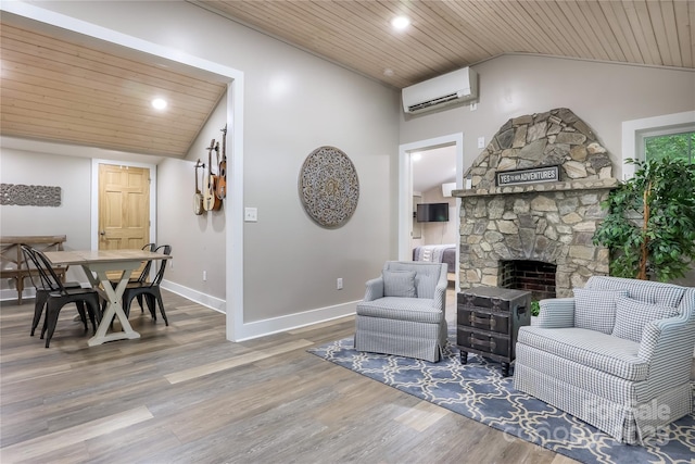 22 Moore Cir, Black Mountain, NC 28711 - living room featuring lofted ceiling, a wall unit AC, wooden ceiling, wood finished floors, and a fireplace