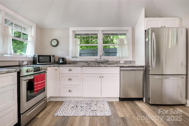 22 Moore Cir, Black Mountain, NC 28711 - kitchen featuring appliances with stainless steel finishes, light stone counters, white cabinetry, and light wood finished floors