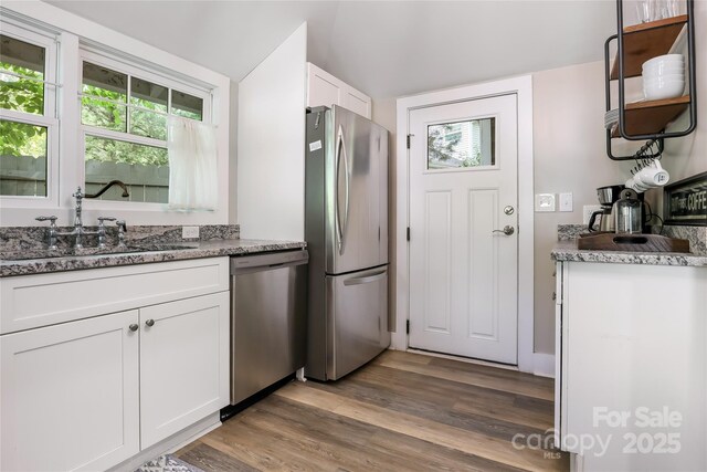 22 Moore Cir, Black Mountain, NC 28711 - kitchen featuring appliances with stainless steel finishes, wood finished floors, white cabinetry, stone countertops, and lofted ceiling