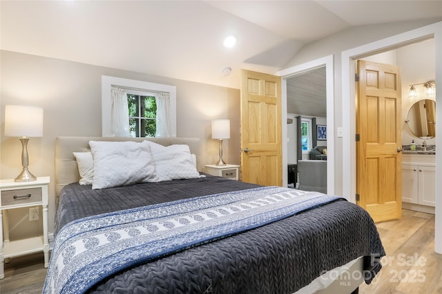 22 Moore Cir, Black Mountain, NC 28711 - bedroom with lofted ceiling, light wood finished floors, and ensuite bathroom