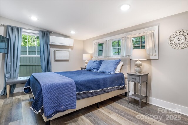 22 Moore Cir, Black Mountain, NC 28711 - bedroom featuring wood finished floors, vaulted ceiling, an AC wall unit, and recessed lighting