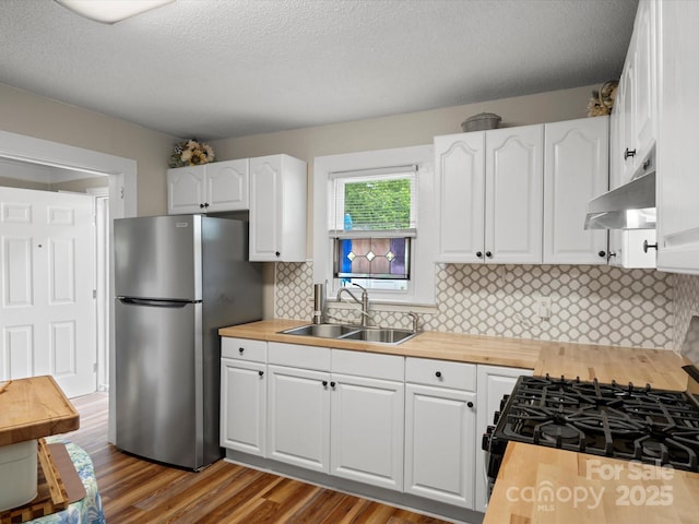 206 Charlotte St, York, SC 29745 - kitchen with a sink, freestanding refrigerator, butcher block counters, white cabinetry, and a textured ceiling