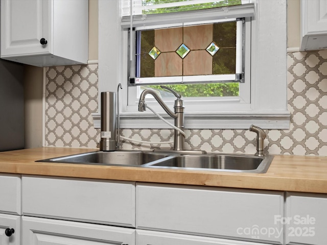 206 Charlotte St, York, SC 29745 - kitchen with white cabinets, decorative backsplash, healthy amount of natural light, and a sink