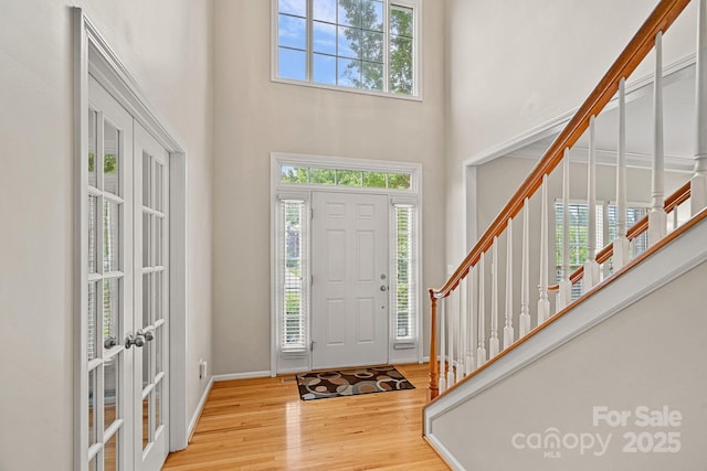 3830 Waters Reach Ln, Indian Trail, NC 28079 - foyer entrance with french doors, plenty of natural light, a high ceiling, wood finished floors, and stairway