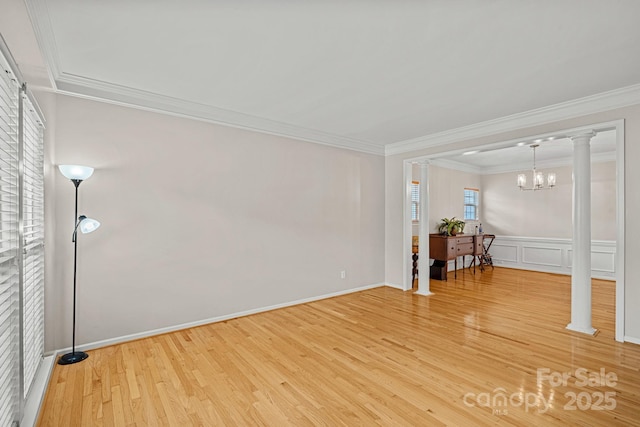 3830 Waters Reach Ln, Indian Trail, NC 28079 - spare room with crown molding, light wood-type flooring, ornate columns, a chandelier, and wainscoting