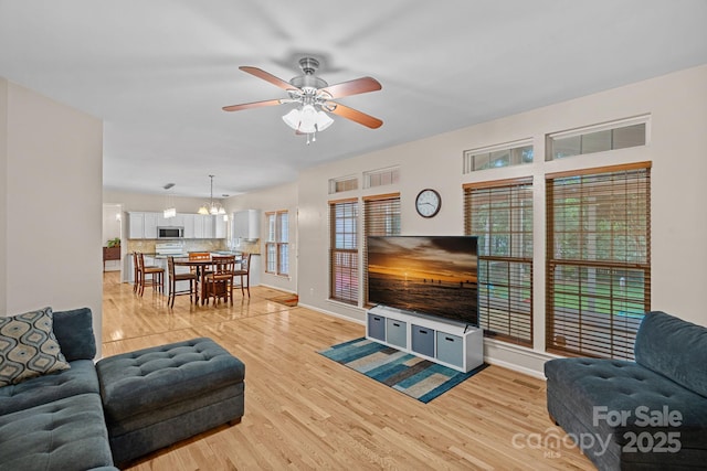 3830 Waters Reach Ln, Indian Trail, NC 28079 - living area with ceiling fan, light wood finished floors, and a chandelier