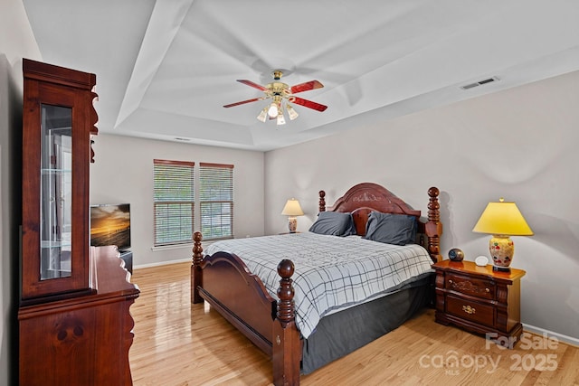 3830 Waters Reach Ln, Indian Trail, NC 28079 - bedroom with a raised ceiling, light wood-type flooring, and a ceiling fan