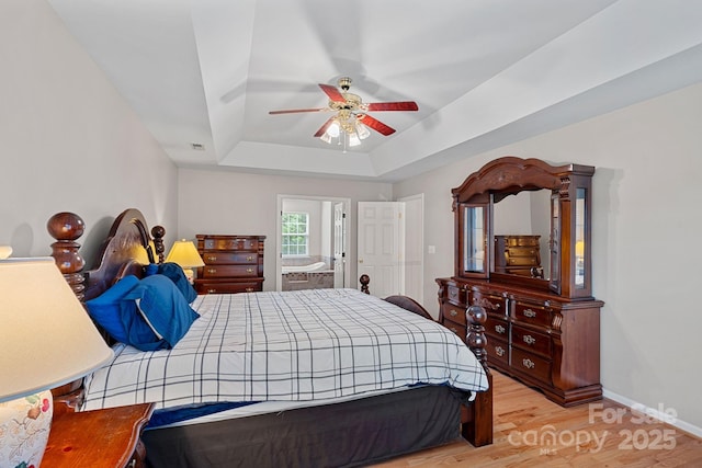 3830 Waters Reach Ln, Indian Trail, NC 28079 - bedroom with a raised ceiling, wood finished floors, and a ceiling fan