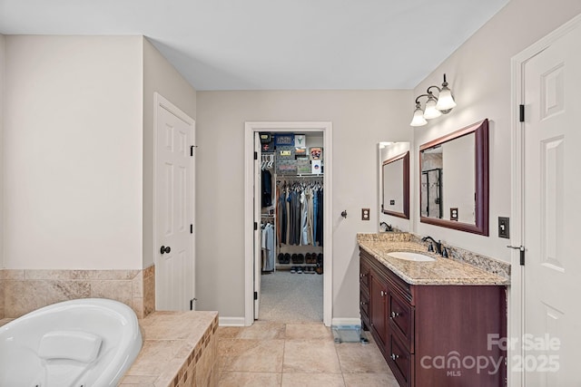 3830 Waters Reach Ln, Indian Trail, NC 28079 - full bath featuring vanity, a garden tub, a walk in closet, and tile patterned floors