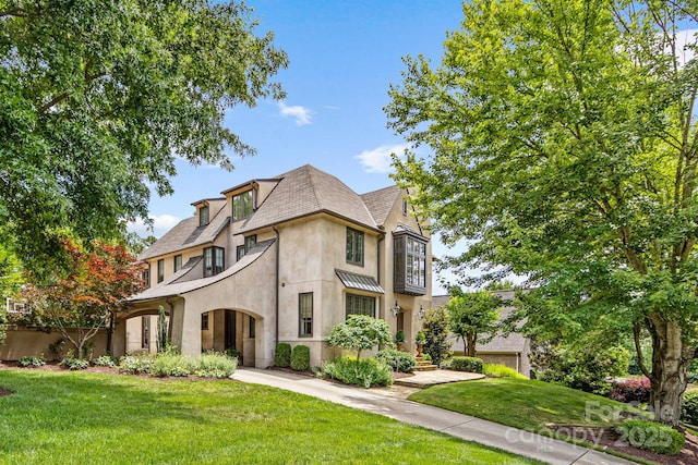 1728 Shadow Forest Dr, Matthews, NC 28105 - view of front of house with stucco siding, a front yard, and roof with shingles