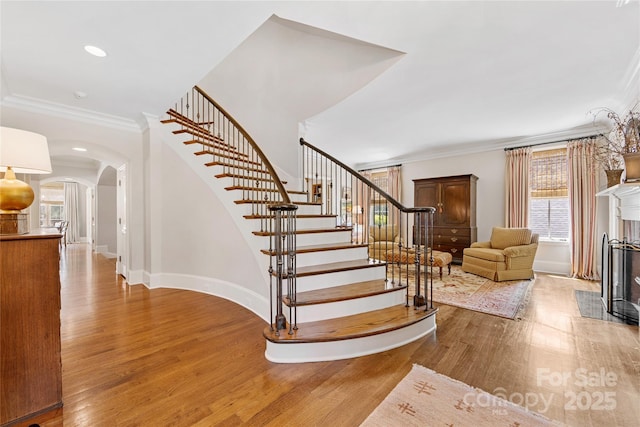 1728 Shadow Forest Dr, Matthews, NC 28105 - staircase with arched walkways, wood finished floors, ornamental molding, baseboards, and recessed lighting