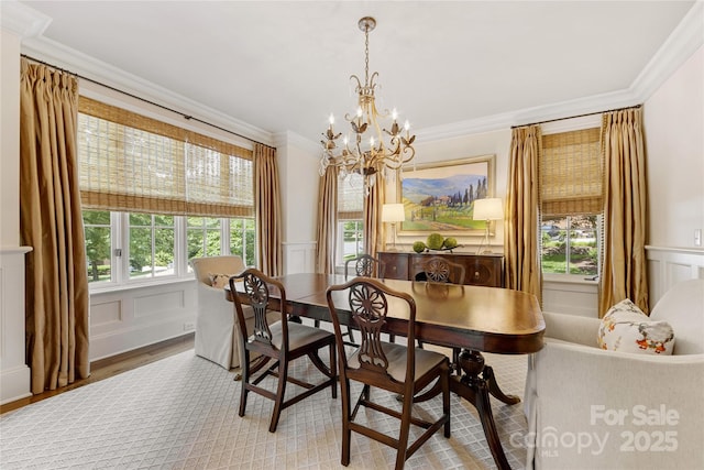 1728 Shadow Forest Dr, Matthews, NC 28105 - dining room with a decorative wall, ornamental molding, a chandelier, light wood-type flooring, and a wainscoted wall