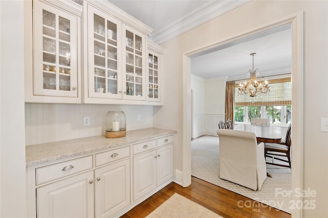 1728 Shadow Forest Dr, Matthews, NC 28105 - kitchen featuring ornamental molding, dark wood-type flooring, glass insert cabinets, a chandelier, and white cabinetry