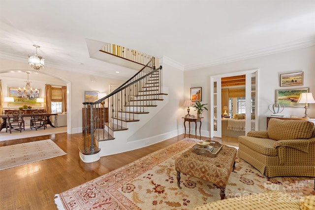 1728 Shadow Forest Dr, Matthews, NC 28105 - living room featuring a chandelier, ornamental molding, stairs, wood finished floors, and baseboards