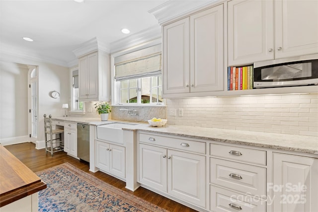 1728 Shadow Forest Dr, Matthews, NC 28105 - kitchen featuring appliances with stainless steel finishes, ornamental molding, dark wood-style floors, white cabinetry, and a sink