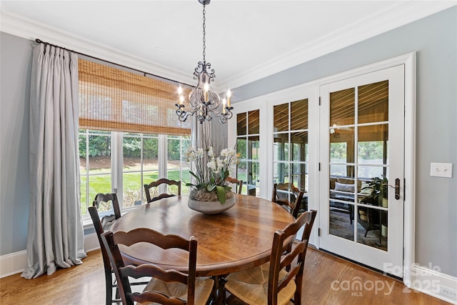 1728 Shadow Forest Dr, Matthews, NC 28105 - dining area with a chandelier, ornamental molding, wood finished floors, and baseboards
