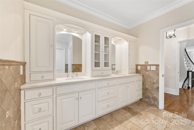 1728 Shadow Forest Dr, Matthews, NC 28105 - full bath with tile walls, double vanity, ornamental molding, and a wainscoted wall