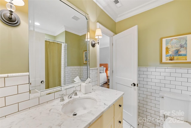 1728 Shadow Forest Dr, Matthews, NC 28105 - bathroom with tile walls, a wainscoted wall, crown molding, vanity, and toilet