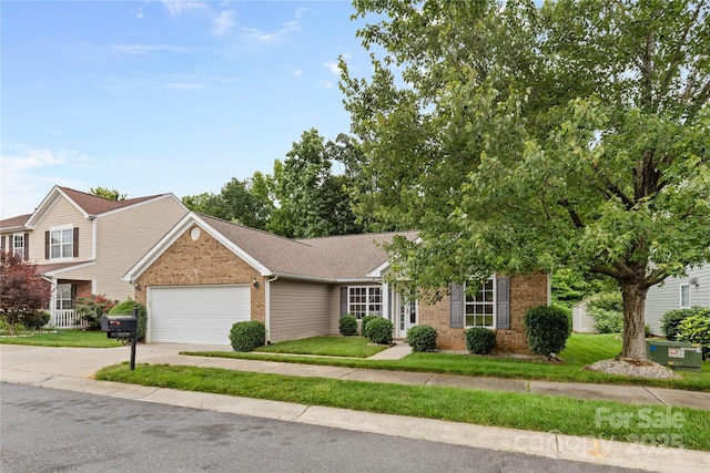 3008 Cornflower Ln, Indian Trail, NC 28079 - view of front of home with brick siding, a garage, driveway, and a front lawn